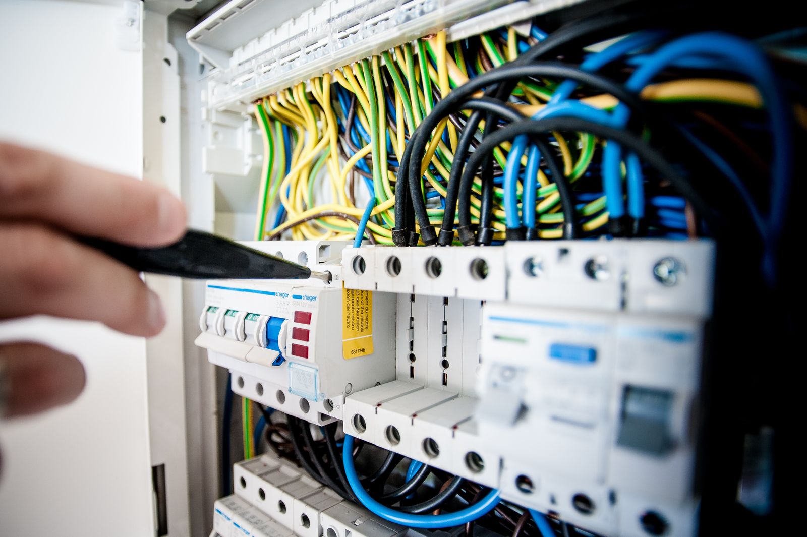 An electrician working on a panel